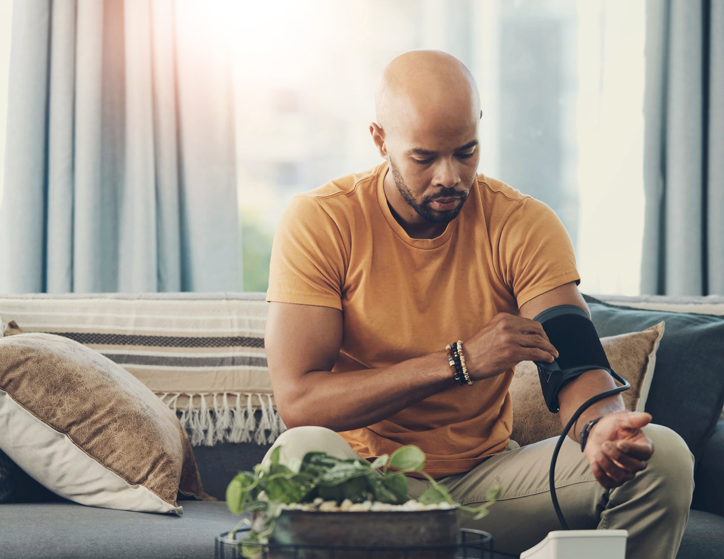man checking blood pressure at home