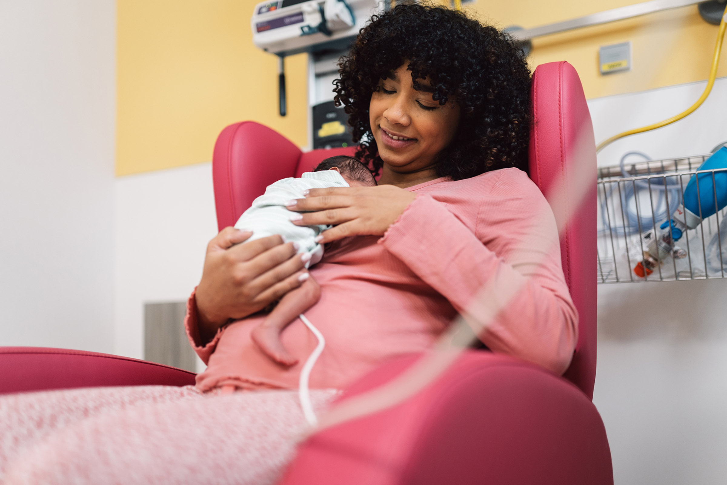 mother holding newborn in hospital