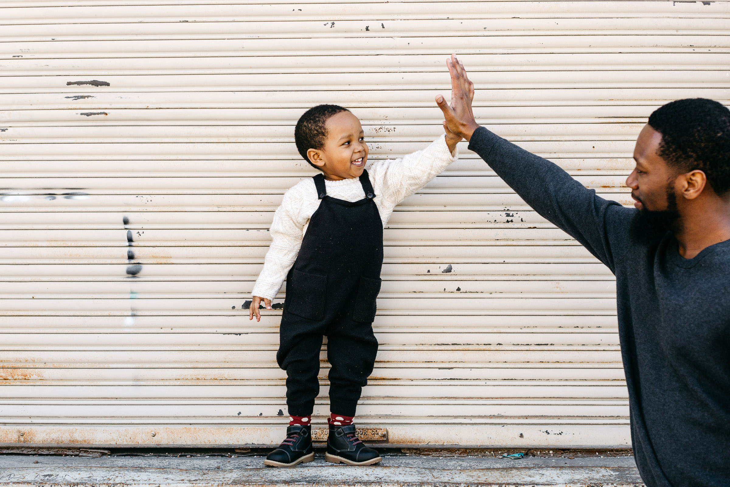 toddler high five with father