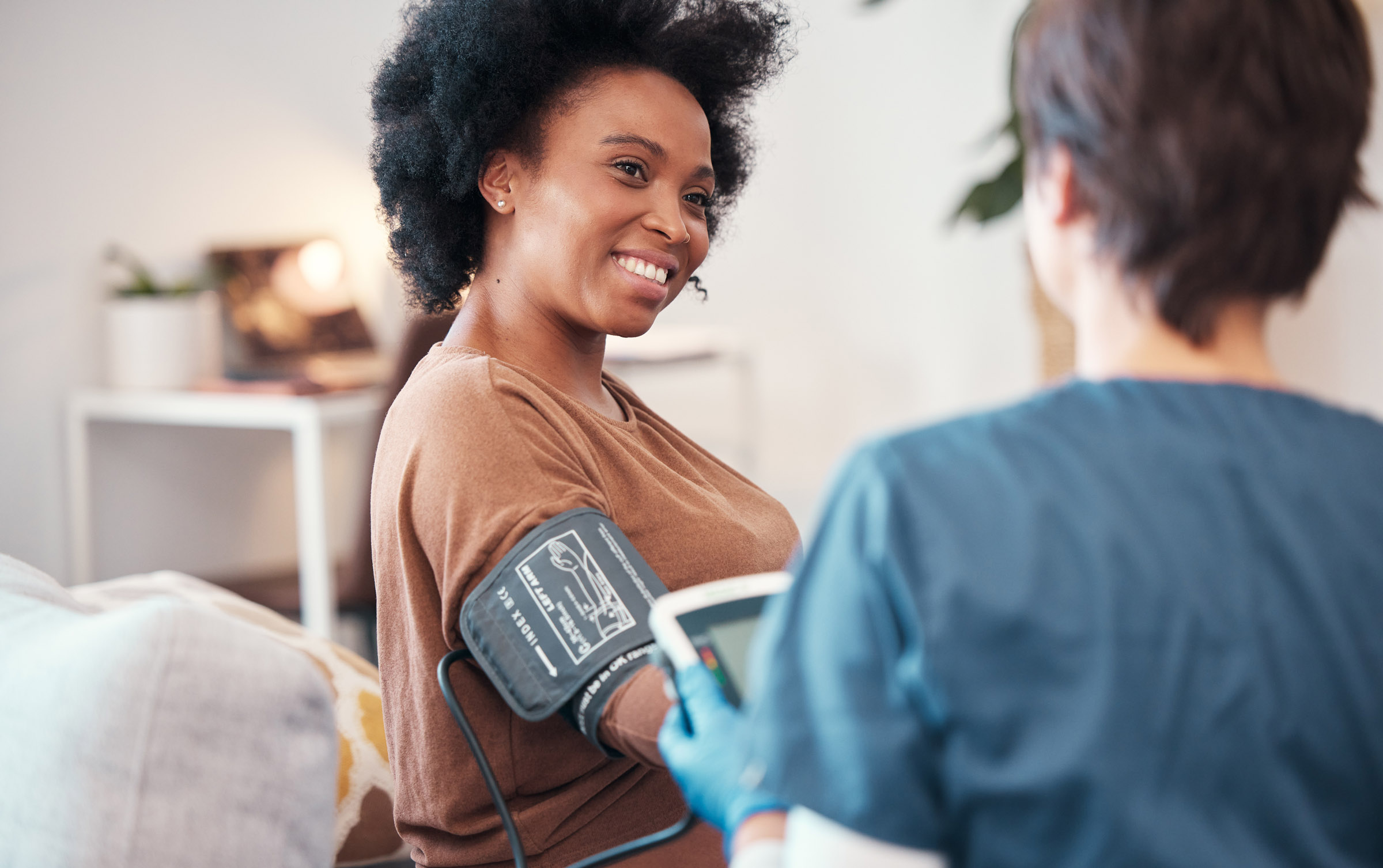 woman blood pressure checked by nurse