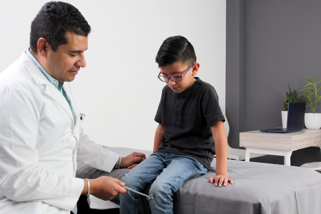 doctor examining boy with glasses exam room doctor examining boy with glasses exam room