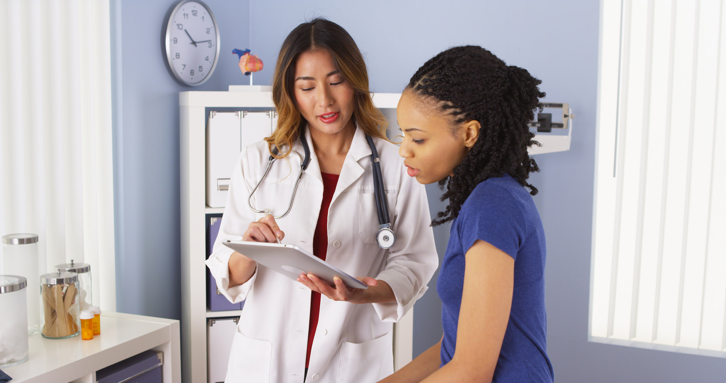 doctor showing tablet results to patient