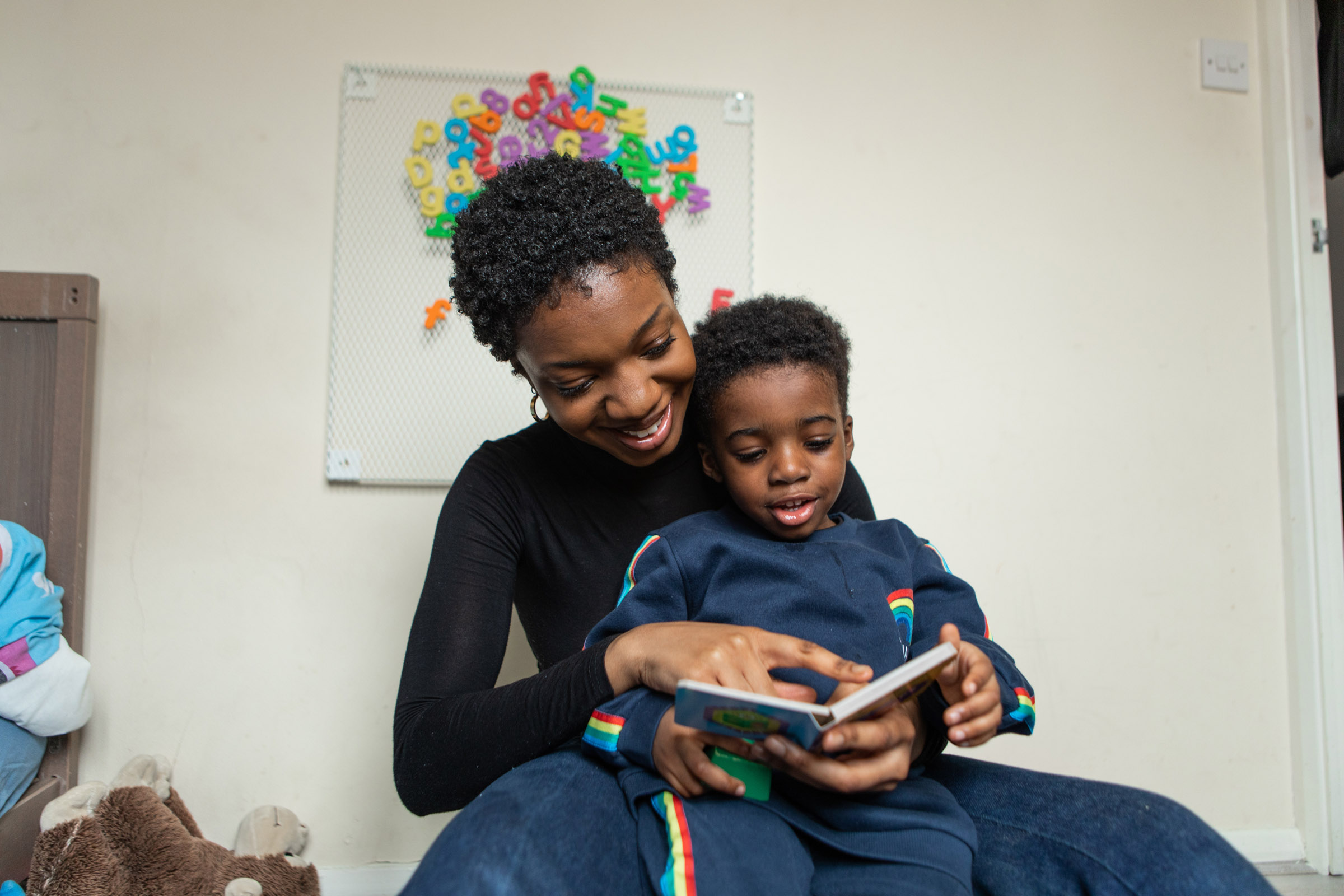 mother reading picture book with son