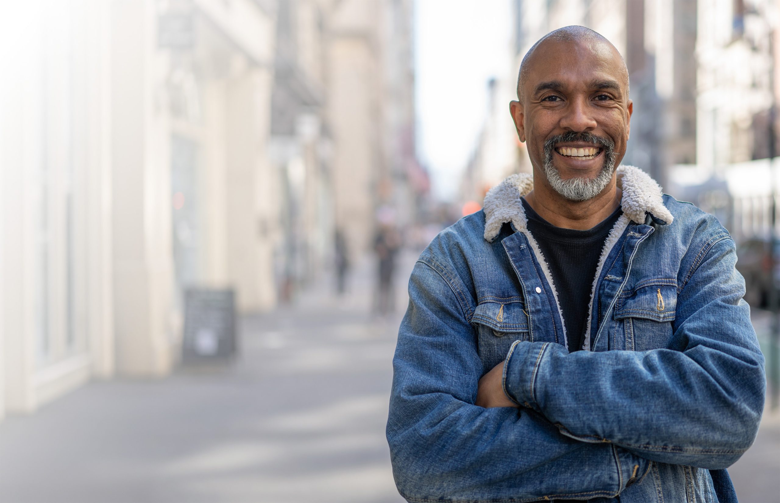smiling man in denim jacket story
