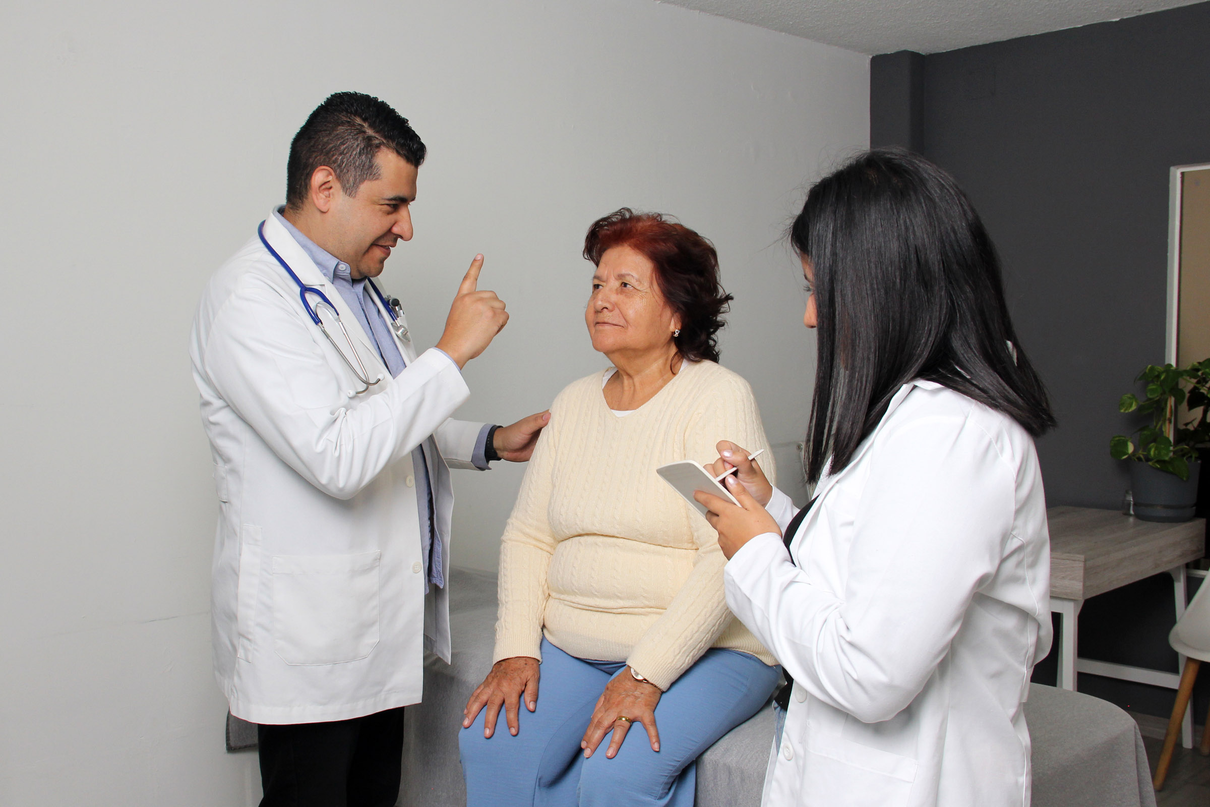 two doctors consulting elderly patient exam room